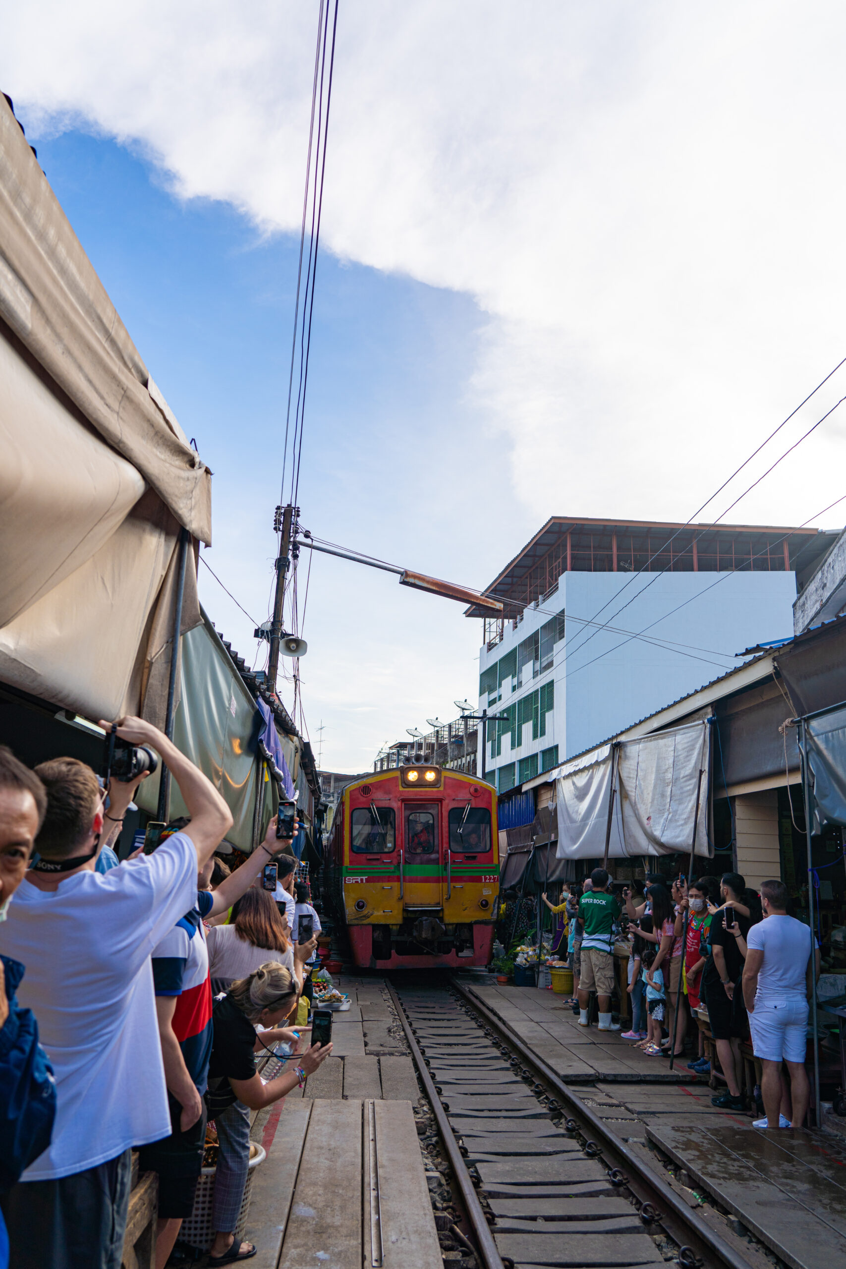 Everyone getting off the Maeklong Railway Market tracks so the train can pass.